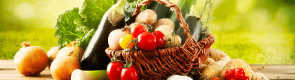 Basket of colorful veggies overflowing on a wooden table