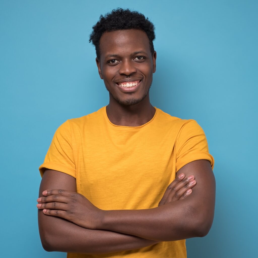 Man smiling with arms crossed.